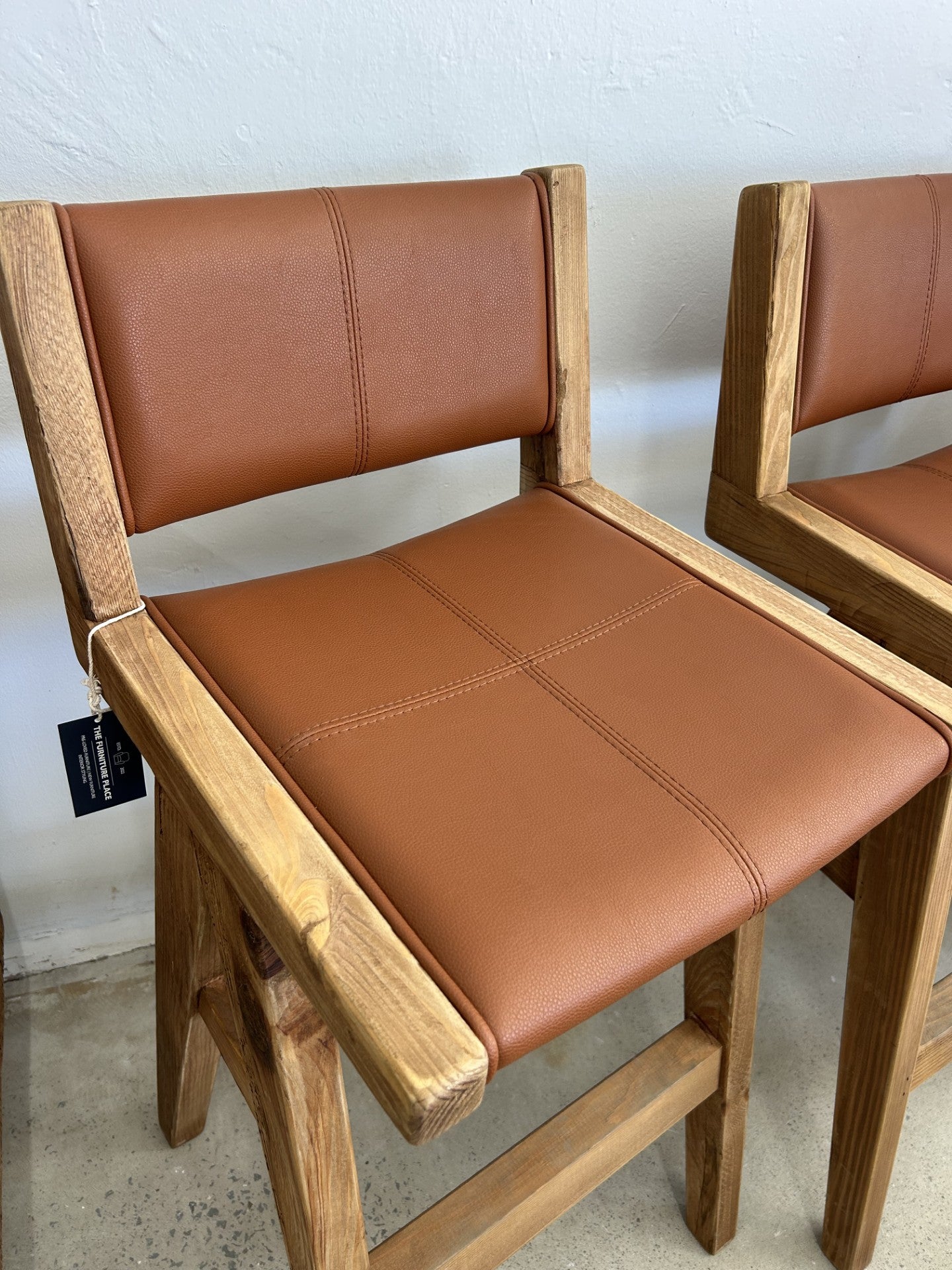 Tan bar stool with comfortable padded seat and backrest for kitchen