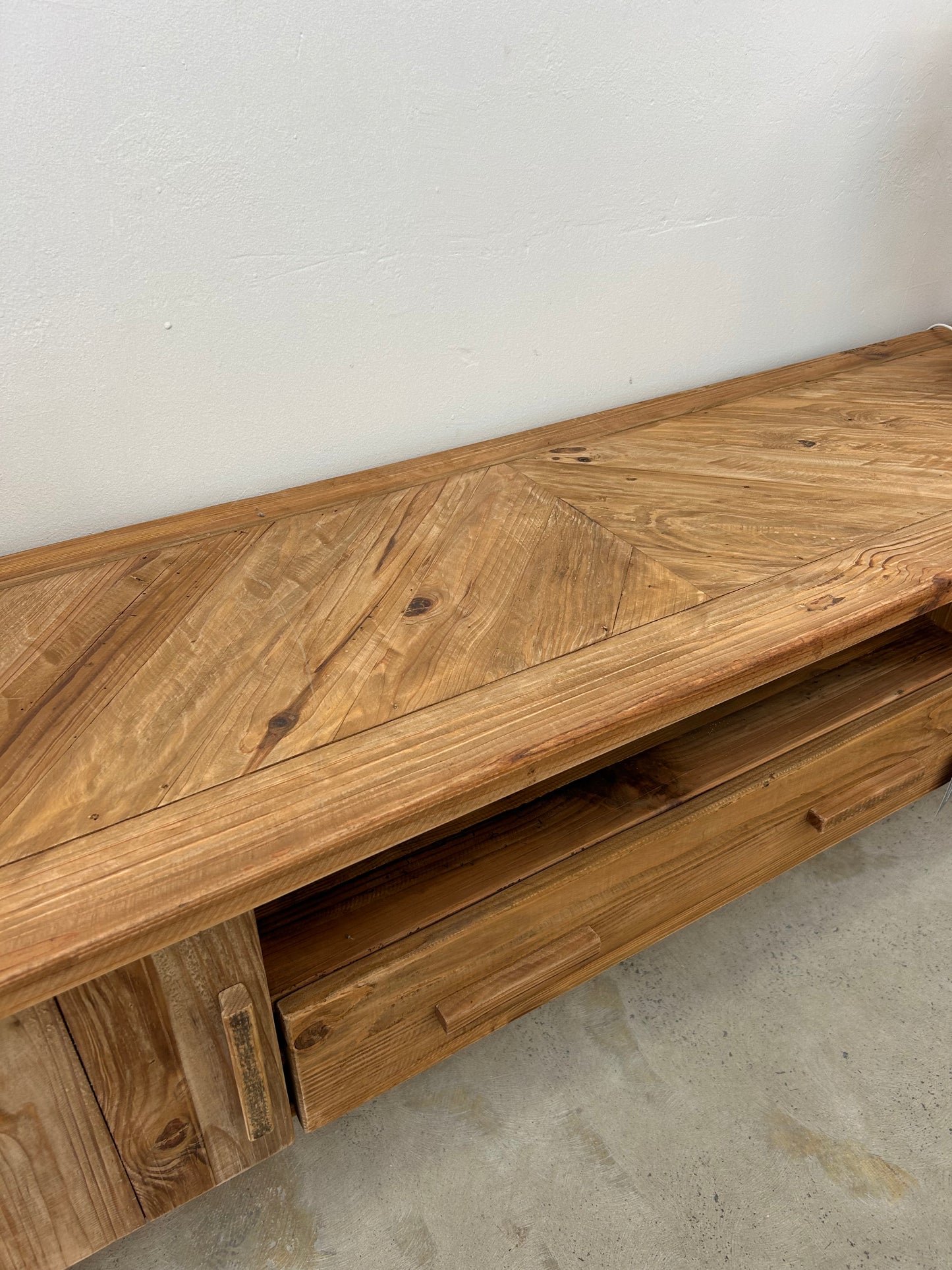 Top of a reclaimed wood TV Unit with wood paneling detail