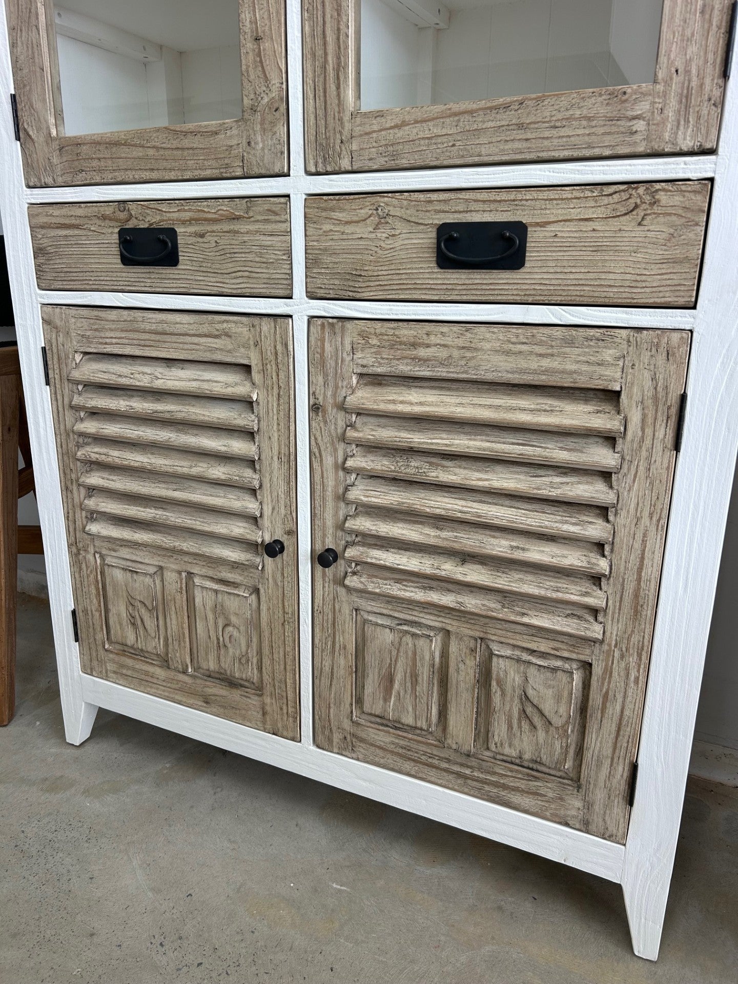 Close up of the timber doors on a white display cabinet