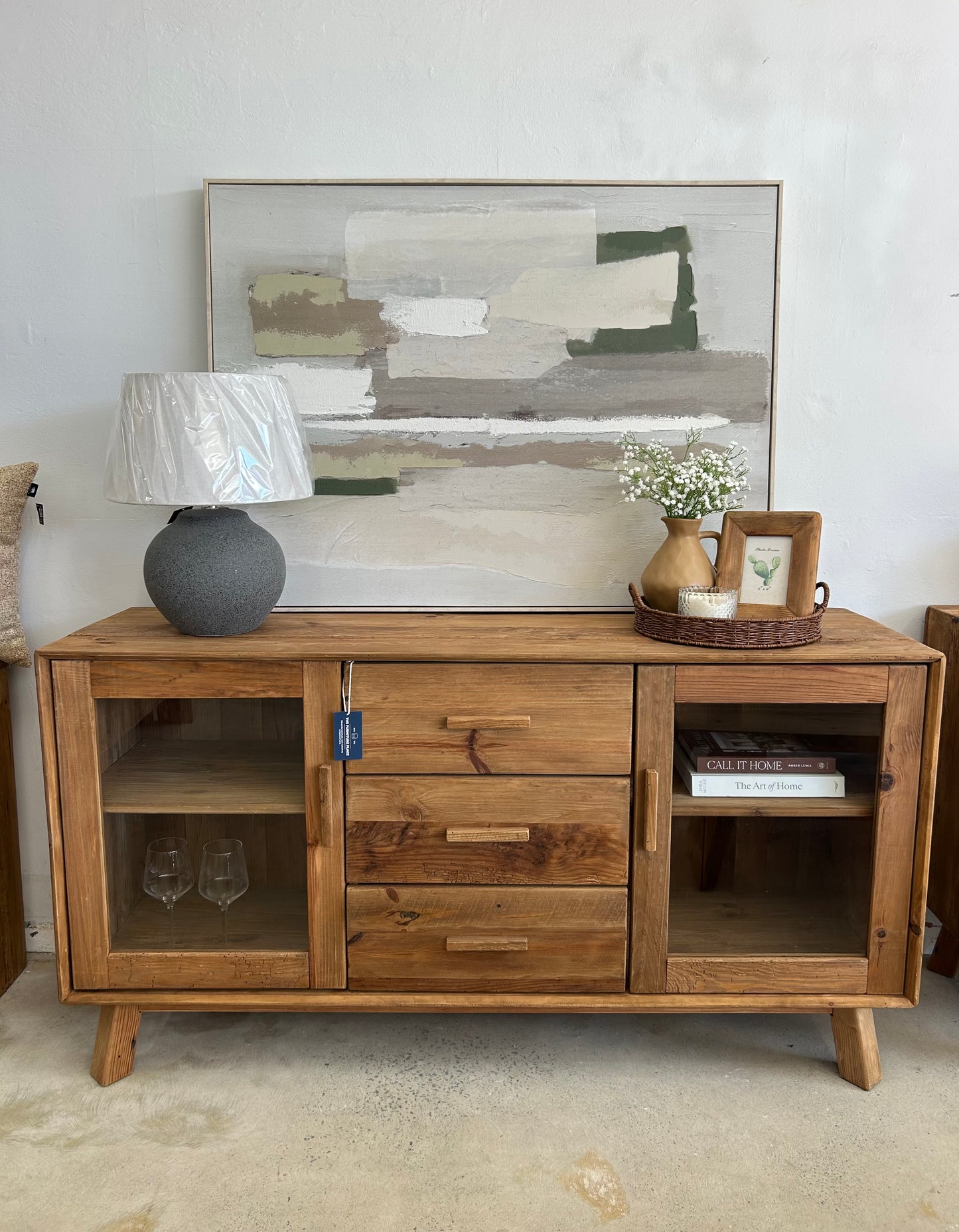 Large black ceramic table lamp on wooden buffet