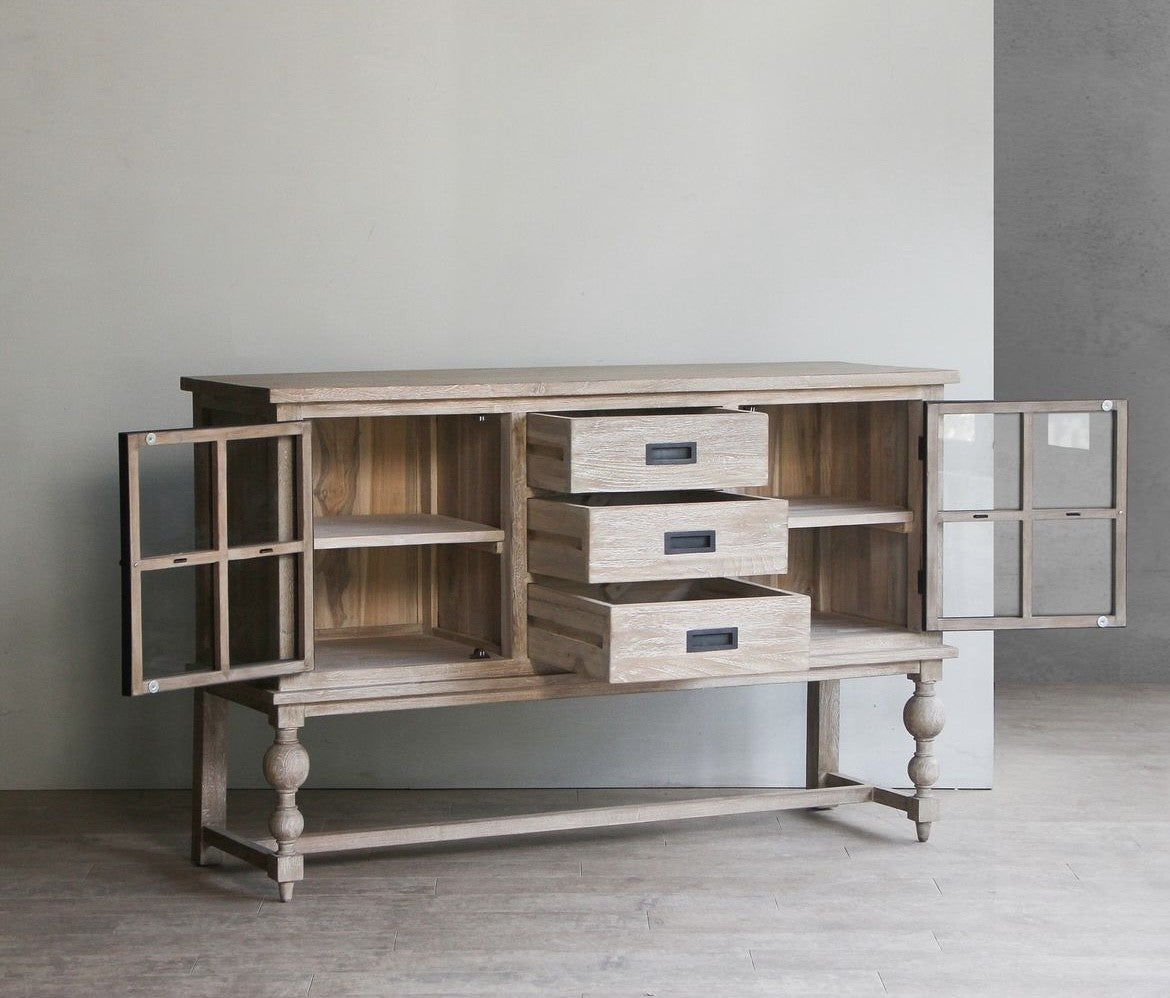 View of drawers and shelving in a buffet or sideboard made of wood with black metal details