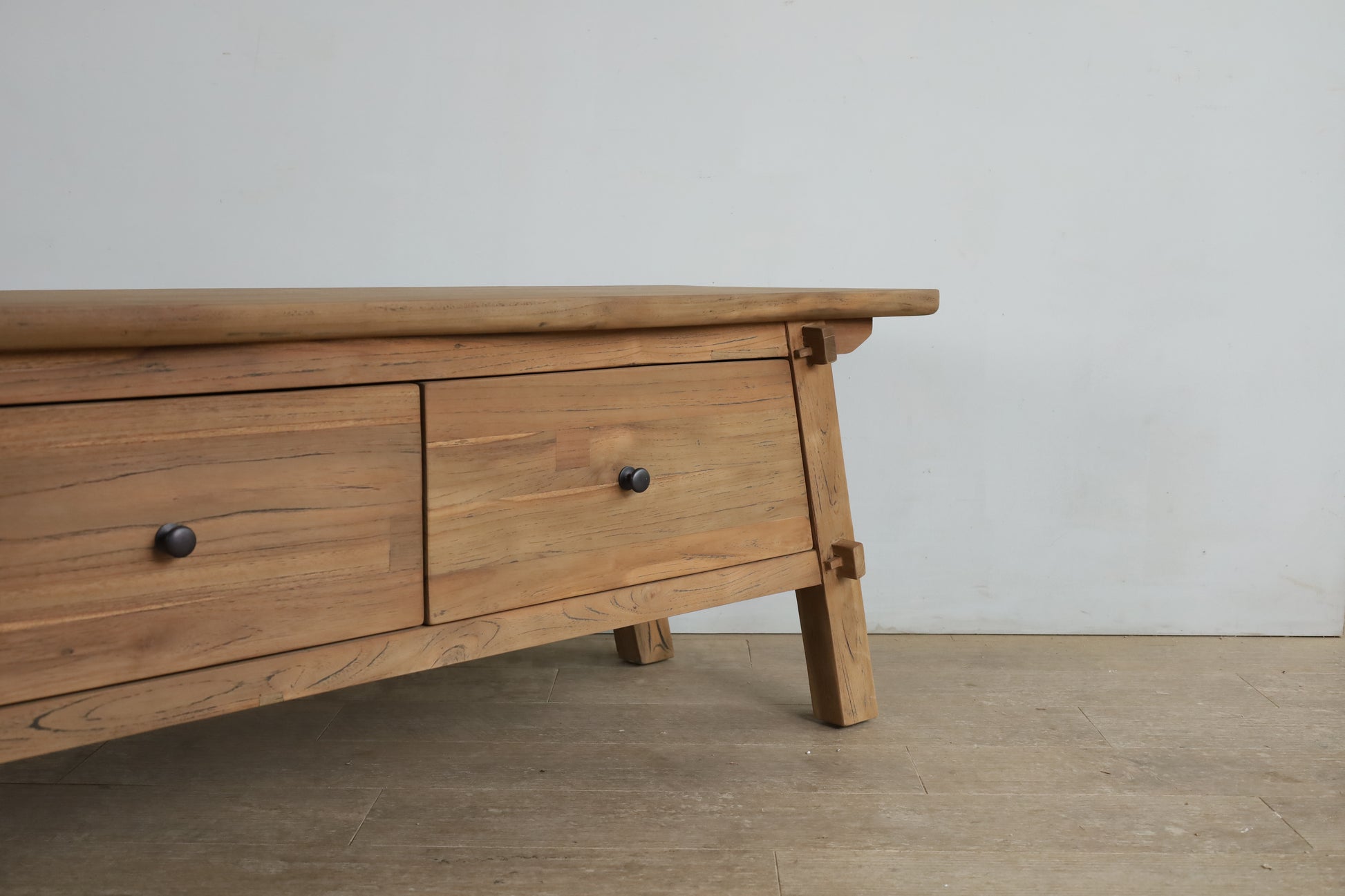 close up of the Portofino TV Unit. A teak wood TV unit with a farmhouse or country design