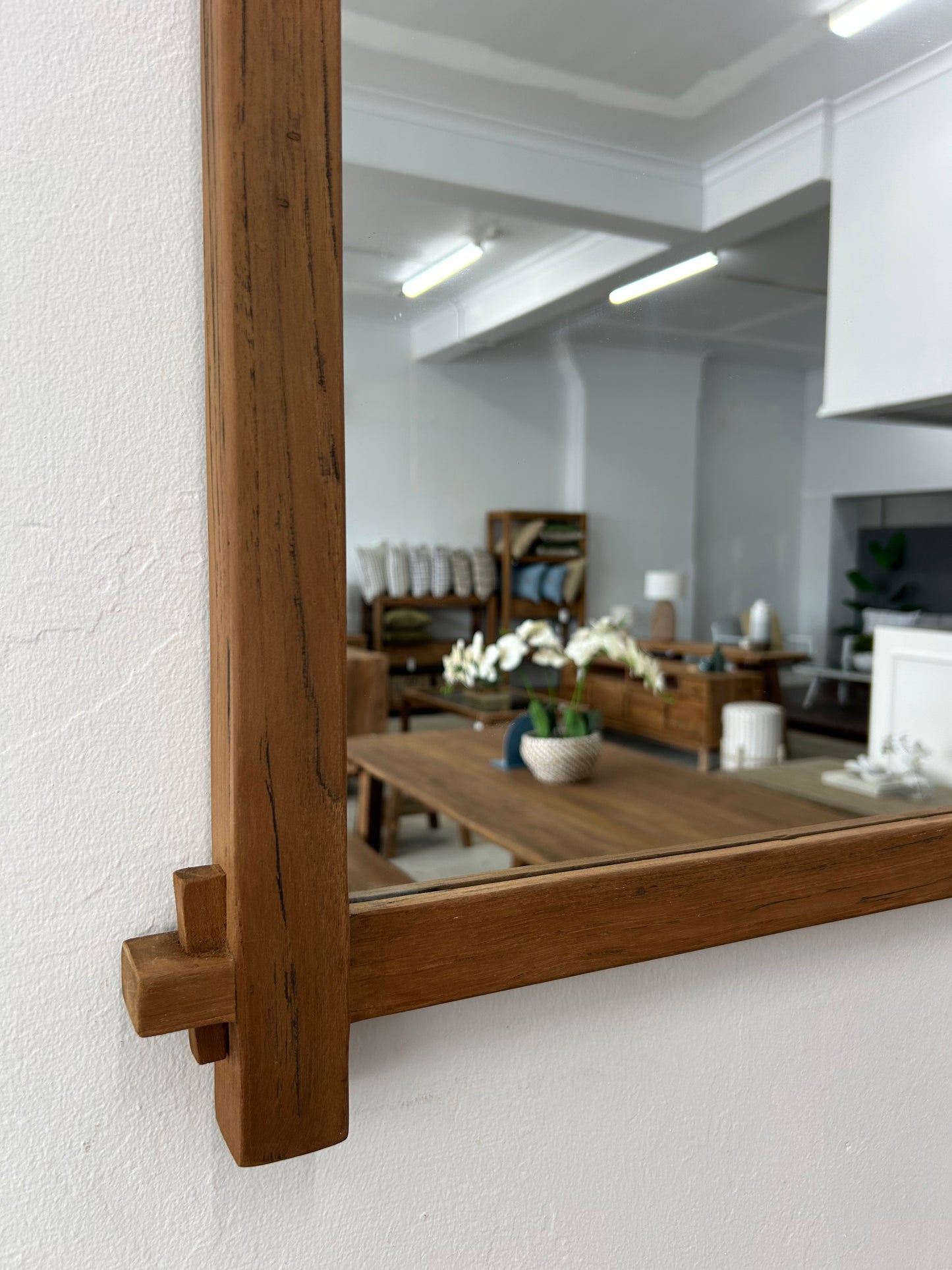 Close up of teak wood wall mirror