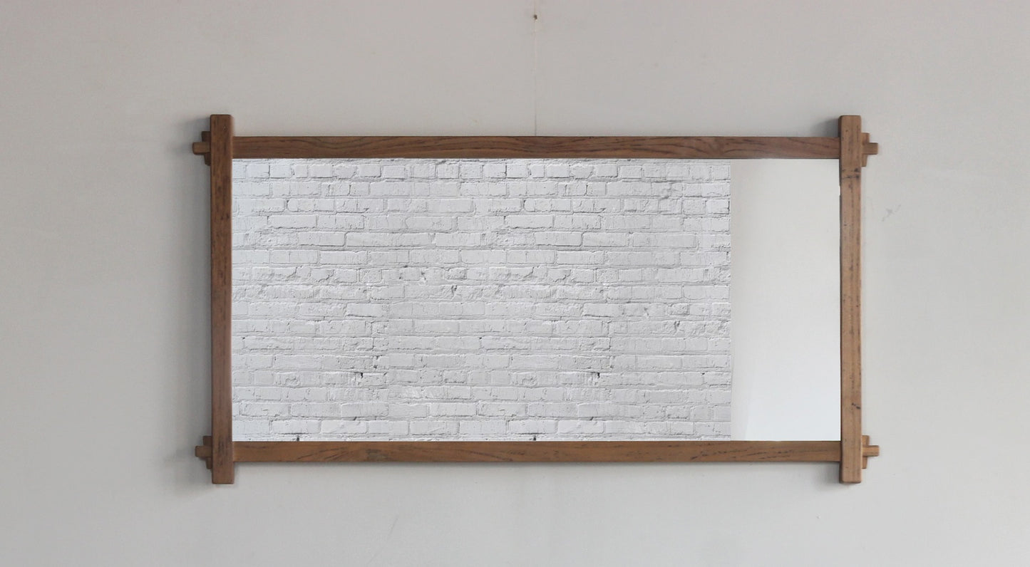 Teak wall mirror with a dark wood frame