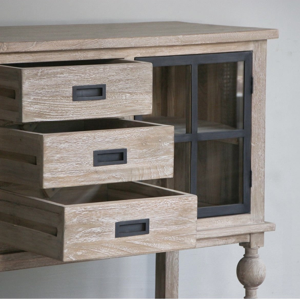 Close up of white washed wooden sideboard buffet with storage. Farmhouse or modern country style.