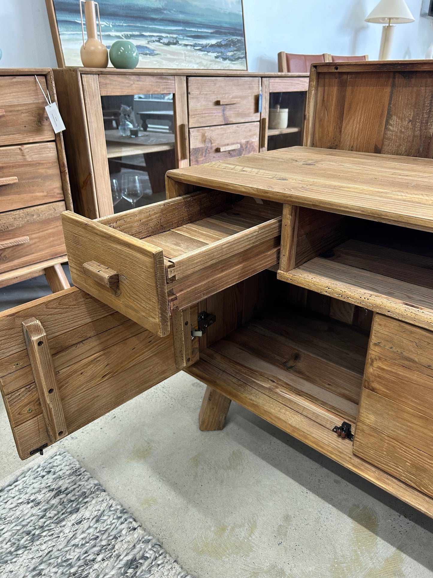 Storage in a farmhouse style TV Unit with rustic and raw wood