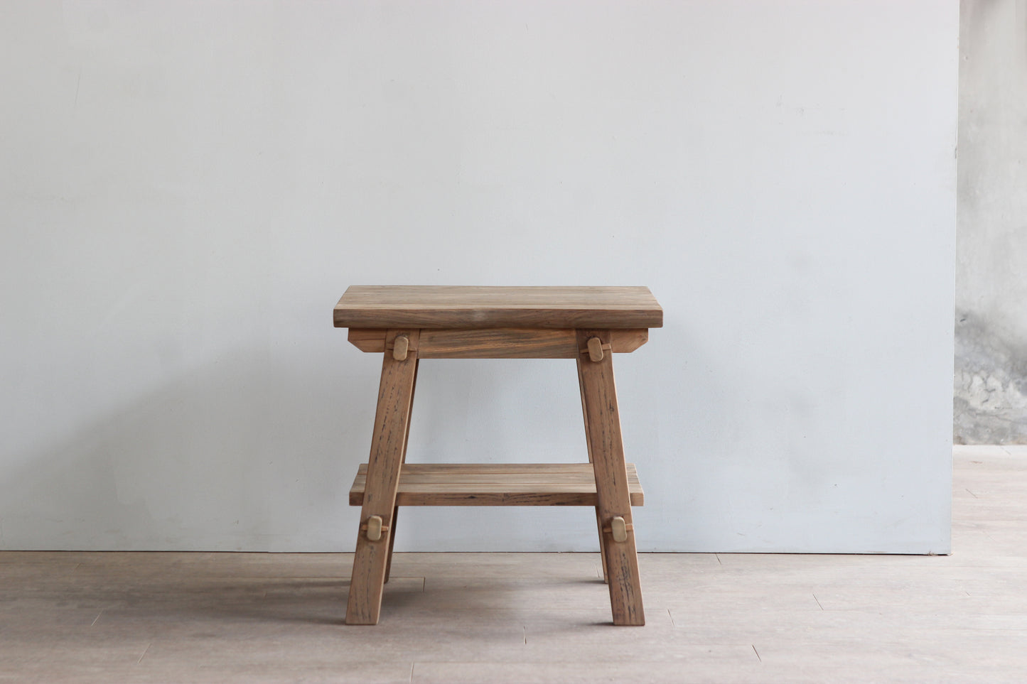 Side view of farmhouse style wooden side table made of reclaimed teak wood