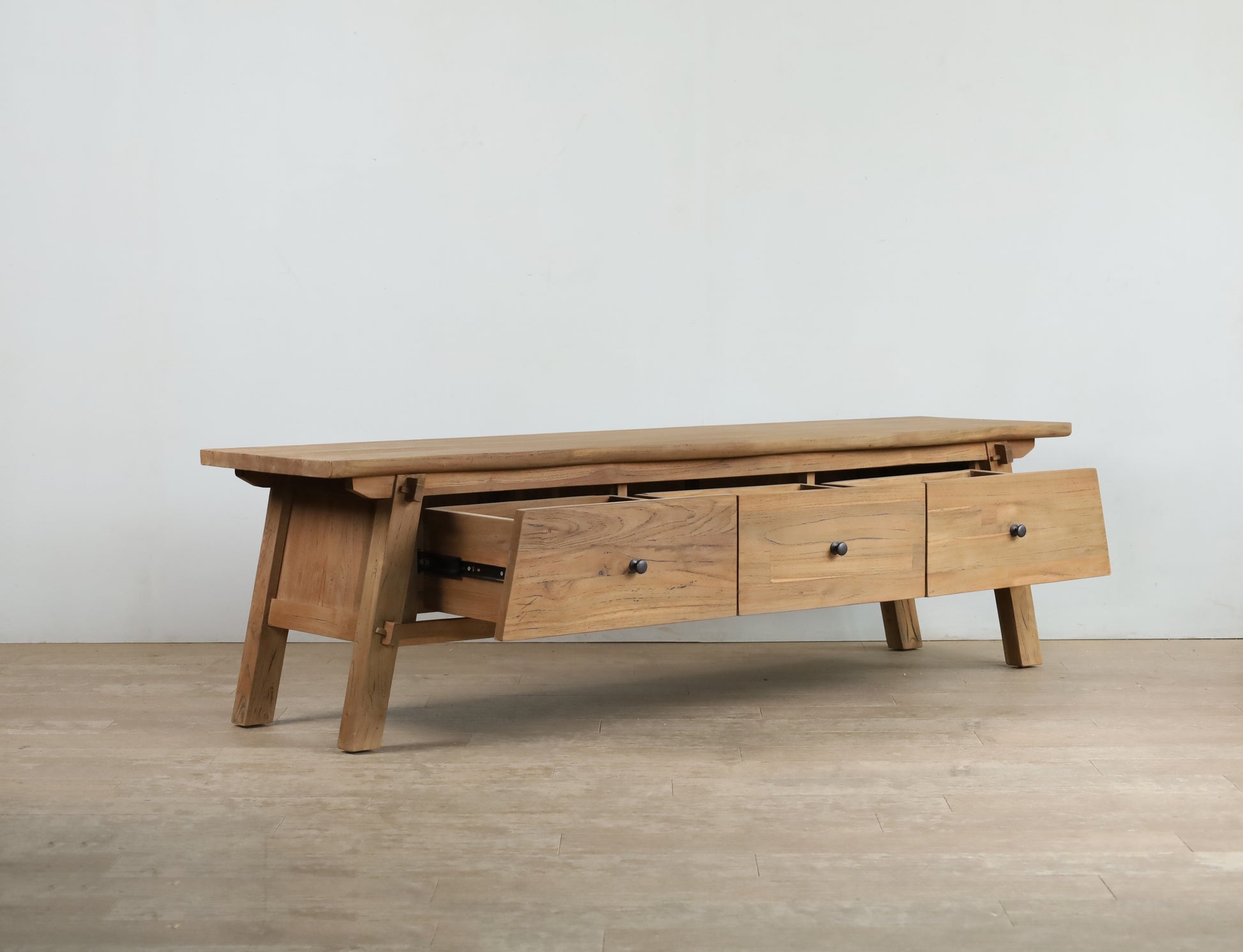 Teak wood TV cabinet with black knob handles, 3 drawers and angled legs