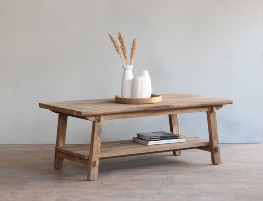 Farmhouse style coffee table with trestle legs and lower shelf