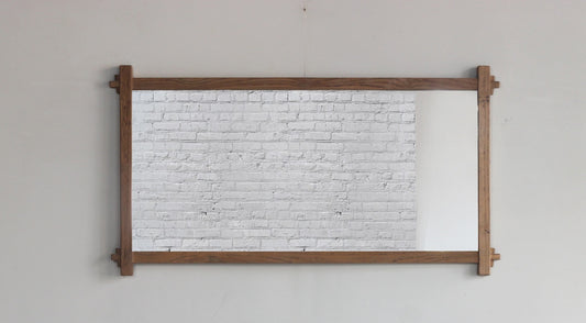 Teak wall mirror with a dark wood frame