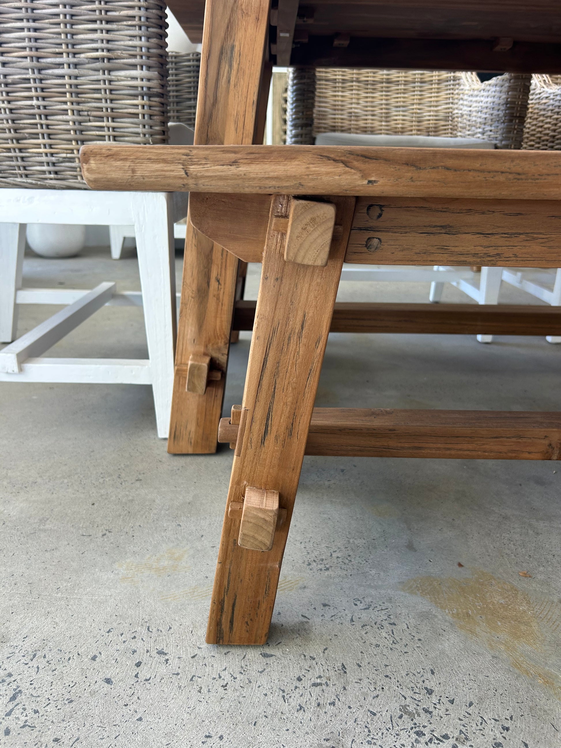 Close up of trestle legs on wooden bench seat