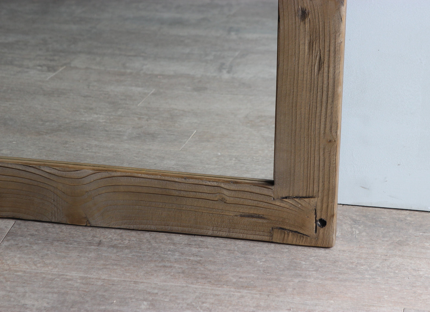 Close up of the wooden frame on a mirror